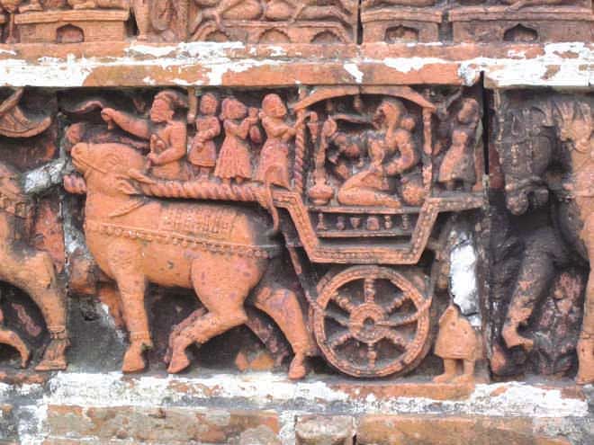 According to terracotta expert Dr Niru Samsunnahar, this  panel of Kantaji Temple illustrates a courtesan travelling  by ox cart. She would have been witty, talented and wise. Photo: Andrew Eagle