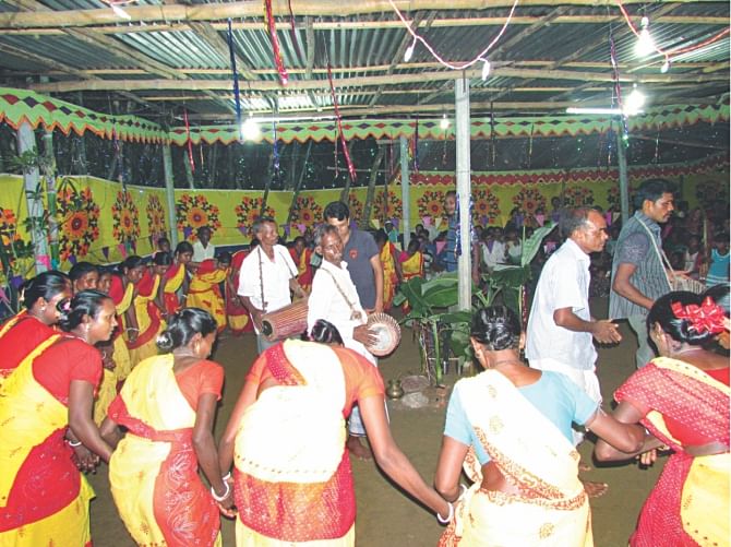 The indigenous people celebrating the Karam Puja through traditional songs in the Thakurgaon district.  Photo: Star
