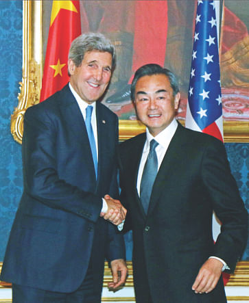 US Secretary of State John Kerry (L) and Chinese Foreign Minister Wang Yi shake hands prior to a bilateral meeting of the closed-door nuclear talks with Iran in Vienna, Austria, yesterday.