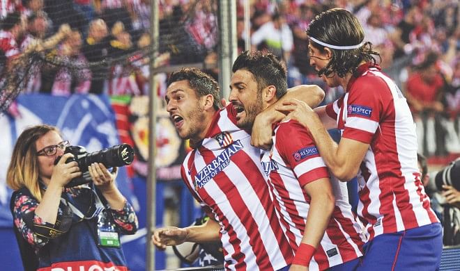 Atletico Madrid midfielder Koke (L) celebrates his all-important goal with teammates David Villa (C) and Filipe Luis during their Champions League quarterfinal at the Vicente Calderon Stadium on Wednesday. Photo: AFP