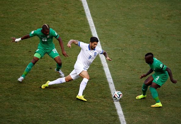 Panagiotis Kone of Greece is challenged by Die Serey (L) and Arthur Boka of the Ivory Coast during the 2014 FIFA World Cup Brazil Group C match between Greece and the Ivory Coast at Castelao on June 24, 2014 in Fortaleza, Brazil. Photo: Getty Images