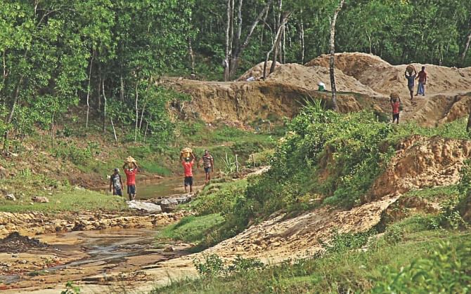 Villagers taking away sand from EPZ land. The photos were taken recently. Photo: Star