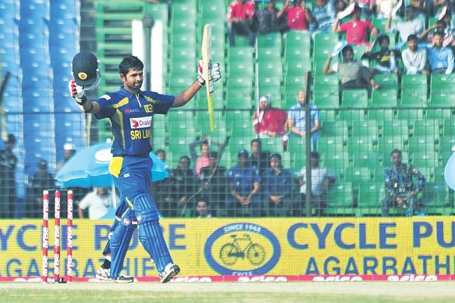 Sri Lanka batsman Lahiru Thirimanne raises his bat on reaching his century against Pakistan in the Asia Cup opener at the Khan Shaheb Osman Ali Stadium in Fatullah yesterday. PHOTO: STAR