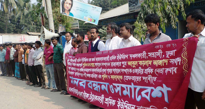 Truck and tank lorry drivers form a human chain at Mission Intersection in Lalmonirhat town yesterday demanding action against extortion from vehicles by 'Pulin-Kamal' group in the name of workers' welfare fund.  PHOTO: STAR