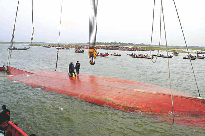 A rescue vessel trying to pull the capsized launch MV Miraj-4 towards the shore of the Meghna in Munshiganj yesterday.  Photo: Star