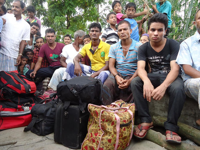 ORDEAL OF HOME-BOUND PEOPLE: Above, passengers wait for alternative transport after their evacuation from the Karnaphuli-1 launch at Kaliganj in Mehandiganj upazila under Barisal district yesterday.  PHOTO: STAR