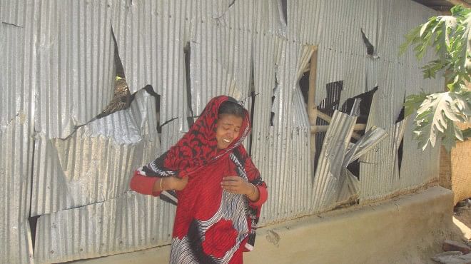 A woman shows all signs of despair as her house at Gopalpur village in Kaliganj upazila under Jhenidah district lies badly damaged after a serious clash between two local factions of ruling Awami league yesterday. PHOTO: STAR