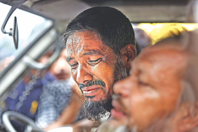 An uncle of Mim, in tears inside the vehicle carrying her body. The eighth grader had gone to her relative's in Faridpur from Gazipur to spend Eid holidays and she drowned on her way back when Pinak-6 went down. Her uncles said they had discouraged her from leaving in the Eid rush on that fateful day but Mim was adamant as she did not want to miss a single day of school. Photo: Rashed Shumon