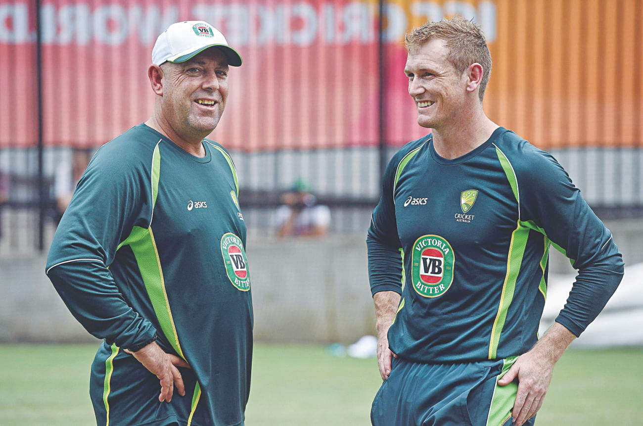 Australia coach Darren Lehmann (L) and stand-in captain George Bailey try to ease the World Cup nerves by sharing a light moment at the Melbourne Cricket Ground during their practice session yesterday.  Photo: AFP 
