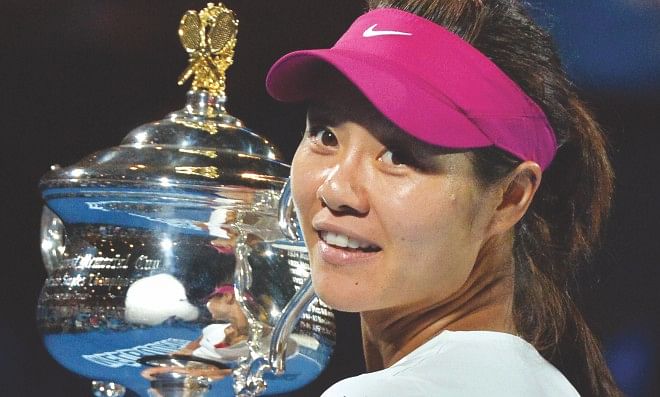 China's Li Na poses with the Australian Open trophy after her victory against Slovakia's Dominika Cibulkova in the women's singles final in Melbourne yesterday. Photo: AFP