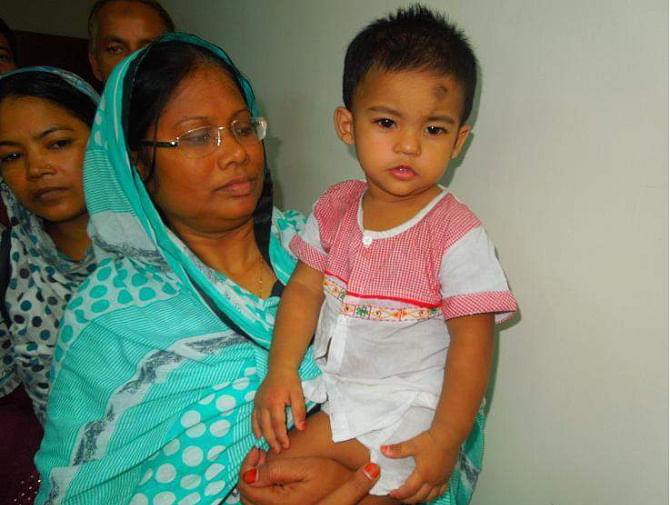 Little Junayed Hasan, abducted for ransom in Nilphamari, returns to his mother's lap on Thursday night. PHOTO: STAR