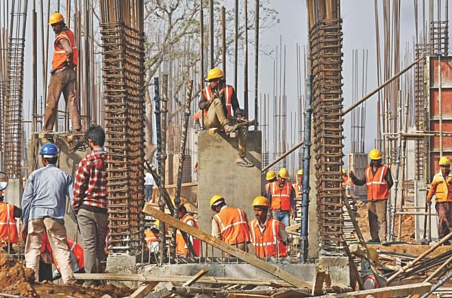 Labourers work at the construction site of an educational institute in the western Indian state of Gujarat. Photo: Reuters