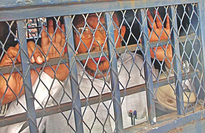 Former state minister for home Lutfozzaman Babar in the prison van in front of the Chittagong court building after he was sentenced to death yesterday for his involvement in the smuggling of 10 truckloads of arms and ammo in 2004. Photo: Anurup Kanti Das