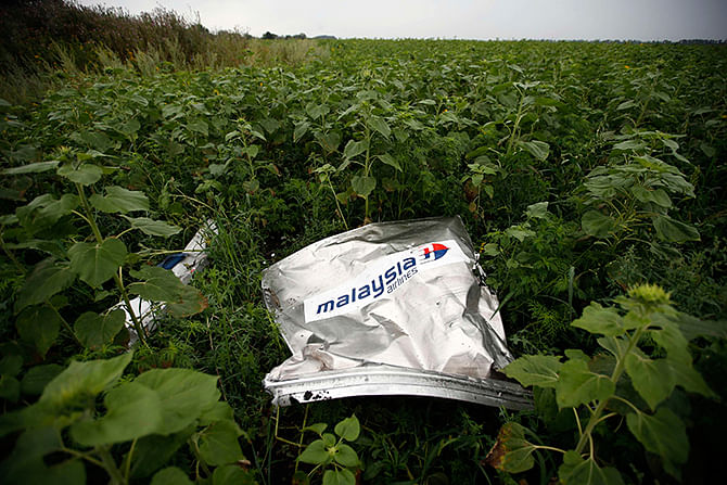 Debris from a Malaysian Airlines Boeing 777 that crashed on Thursday lies on the ground near the village of Rozsypne in the Donetsk region in this July 18, 2014 Reuters file photo. 