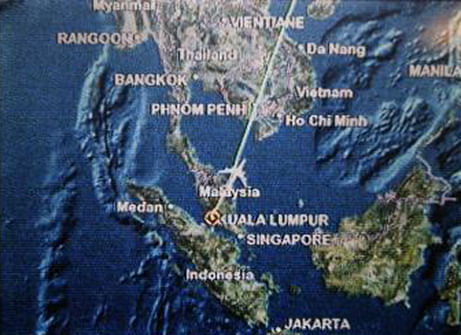 A screen on board Malaysia Airlines Boeing 777-200ER flight MH318 shows the plane's flight path as it cruises over the South China Sea from Kuala Lumpur towards Beijing, at approximately the same point when on March 8 flight MH370 lost contact with air traffic controllers, at approximately 1.30am March 17. Photo: Reuters  