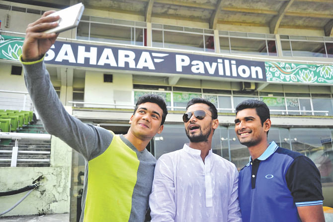 Bangladesh ODI skipper Mashrafe Bin Mortaza stands between Mahmudullah Riyad and Taskin Ahmed (L), as the youngster snaps a selfie of the trio at the Sher-e-Bangla National Stadium yesterday.  PHOTOS: STAR