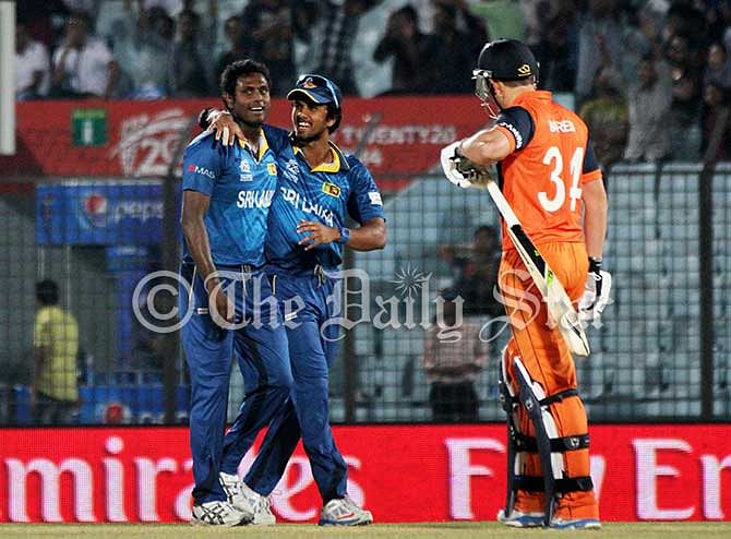 Sri Lankan skipper Dinesh Chandimal congratulates Angelo Mathews for picking up the wicket of Dutch batsman Wesley Barresi at Chittagong stadium today. Photo: Anurup Kanti Das
