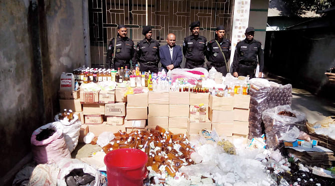 Members of Rapid Action Battalion (Rab) unearthed a fake herbal medicine factory in Akur Takur Para area of Tangail town yesterday and arrested its owner Firoz Khan. A mobile court later sentenced the owner to seven days' imprisonment. Photo: Star