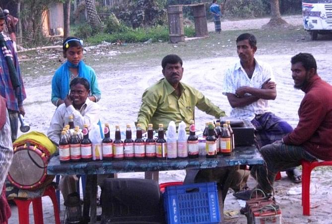 TREATMENT OR CHEATING? ..... Two men sell unauthorised syrup, claiming it to be a panacea, at Dashmina Bazar in Patuakhali, a few days ago. Photo: PHOTO: STAR
