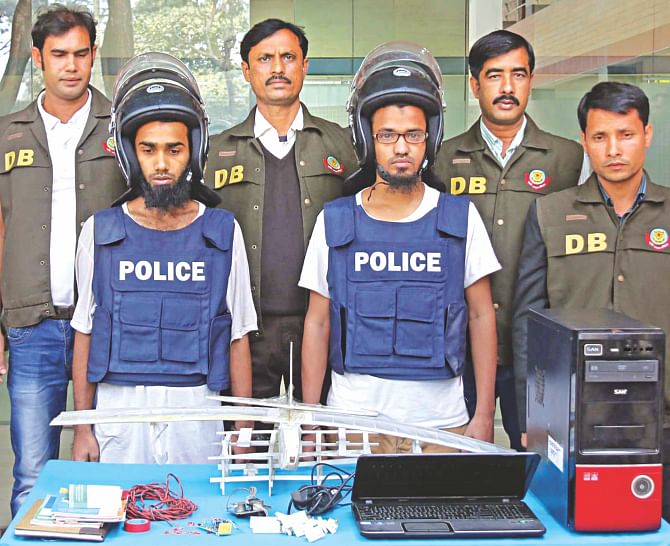 Members of the Ansarullah Bangla Team Tanjil, left, and Mohan with their plastic frame of a drone at the DB media centre yesterday. Police claim that the duo had been trying to use toy plane technology to build drones and carry out attacks. Photo: Banglar Chokh