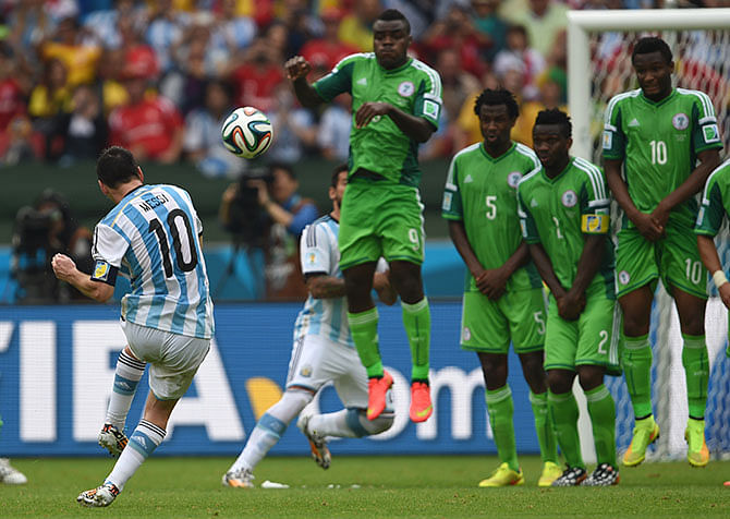 Argentina’s Lionel Messi shoots to score his second goal against Nigeria in the Group F football match at the Beira-Rio Stadium in Porto Alegre during the 2014 FIFA World Cup. Photo: Getty Images
