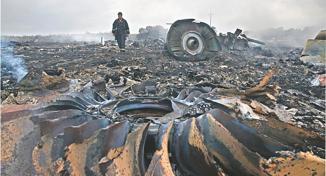 An emergencies ministry member walks at a site of a Malaysia Airlines Boeing 777 plane crash near the settlement of Grabovo in Donetsk region of Ukraine yesterday. Photo: Reuters