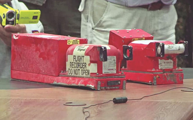 This image grab shows the two black boxes recovered from the crash site of the MH17 jet during their hand over ceremony to Malaysian officials in Donetsk, yesterday.  Photo: AFP