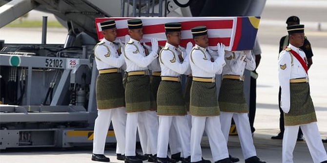 The coffins are draped in the national flag of Malaysia. Photo: AP