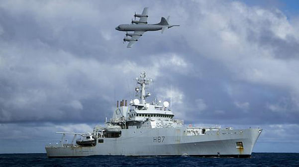 A Royal Australian Air Force (RAAF) AP-3C Orion aircraft flies past the British naval ship HMS Echo in the southern Indian Ocean as they continue to search for the missing Malaysia Airlines flight MH370 in this handout picture released by the Australian Defence Force April 15. Photo: Reuters  