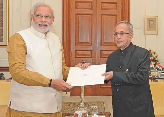 President Pranab Mukherjee hands over the letter of appointment as PM to Narendra Modi at Rashtrapati Bhavan in New Delhi yesterday, inviting the BJP leader to form the next government. Photo: Press Information Bureau, India