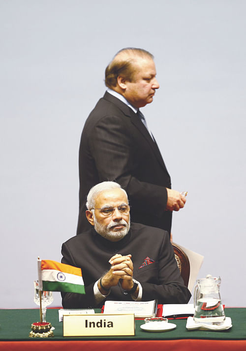 The Prime Minister of Pakistan Nawaz Sharif (Top), walks past the Prime Minister of India Narendra Modi after addressing the opening session of the 18th Saarc summit in the Nepalese capital Kathmandu, yesterday. Photo: AFP