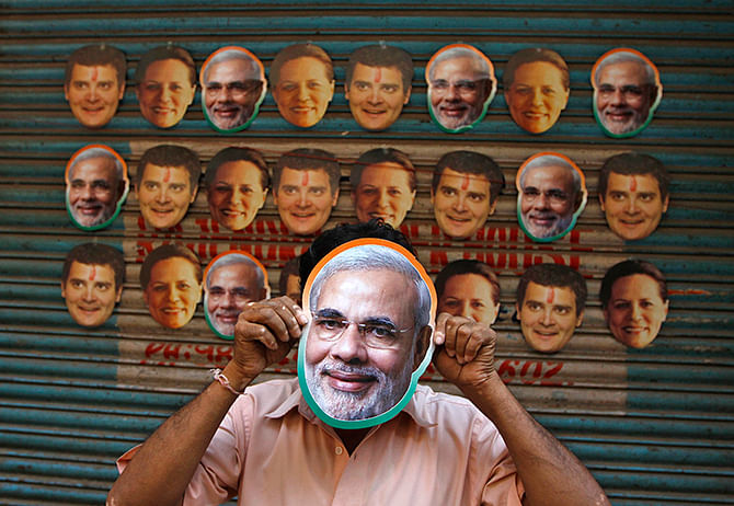 This April 3 photo of Reuters shows a vendor wearing a mask of Hindu nationalist Narendra Modi, prime ministerial candidate for main opposition Bharatiya Janata Party (BJP) and Gujarat's chief minister, to attract customers at his stall selling masks of Indian political leaders ahead of polls in southern Indian city of Chennai. 