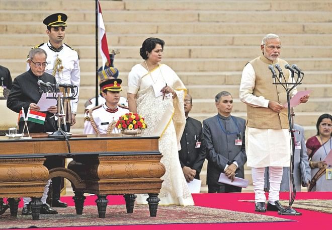 Narendra Modi (R) takes the oath of office as he is sworn in as India's Prime Minister in New Delhi yesterday.  Photo: AFP