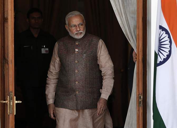 India's Prime Minister Narendra Modi comes out of a meeting room to receive his Bhutanese counterpart Tshering Tobgay before the start of their bilateral meeting in New Delhi May 27. Photo: Reuters