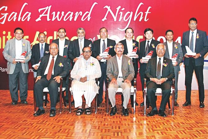 Seated second from left, Rashed Khan Menon, civil aviation and tourism minister, poses with the winners of the Monitor Airline of the Year 2014 awards, at Sonargaon Hotel in Dhaka on Sunday. Photo: Triune