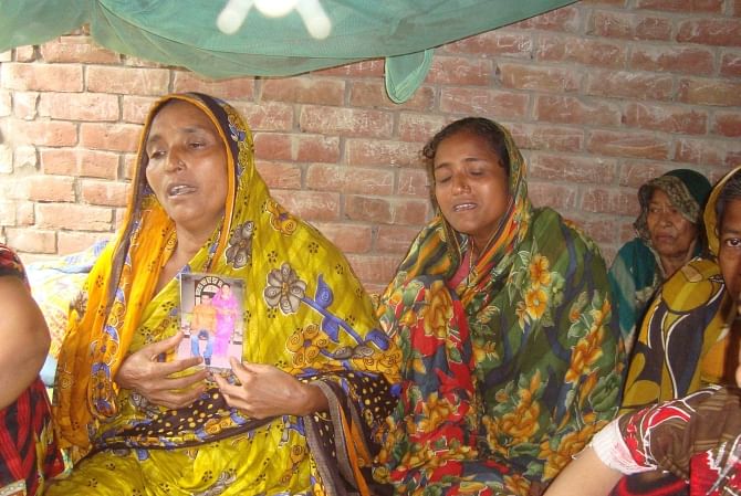 Mother of deceased Milon Hossain cannot hold back her tears as she laments the death of her son at her village home in Moheshpur upazila of Jhenidah yesterday. Photo: Star