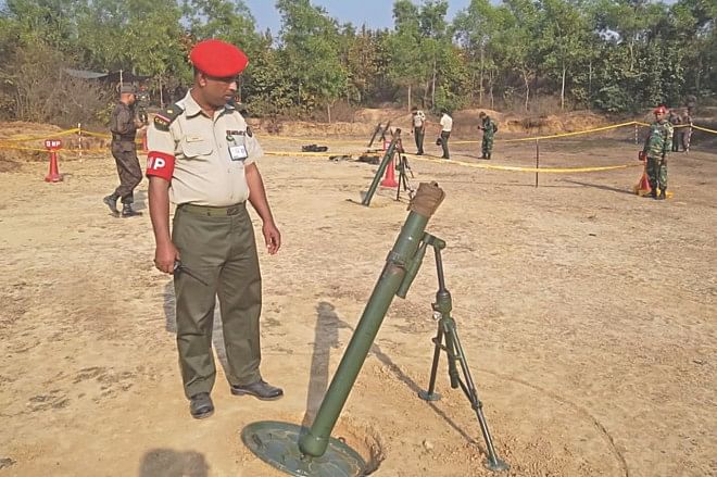 A military police officer looks at a mortar at the Ghatail Cantonment firing range in Tangail. The explosion of a shell inside a similar mortar killed six men of the army and the BGB yesterday. Photo: Star