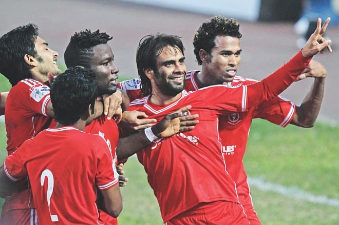 Muktijoddha striker Enamul Haque (C) is the toast of his teammates after scoring the opening goal of his team's 2-1 victory over defending champions Sheikh Russel in their Bangladesh Premier League match at the Bangabandhu National Stadium yesterday. PHOTO: STAR