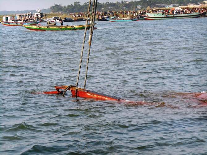 In this May 16 photo, a rescue vessel trying to pull the capsized launch MV Miraj-4 towards the shore of the Meghna in Munshiganj. 
