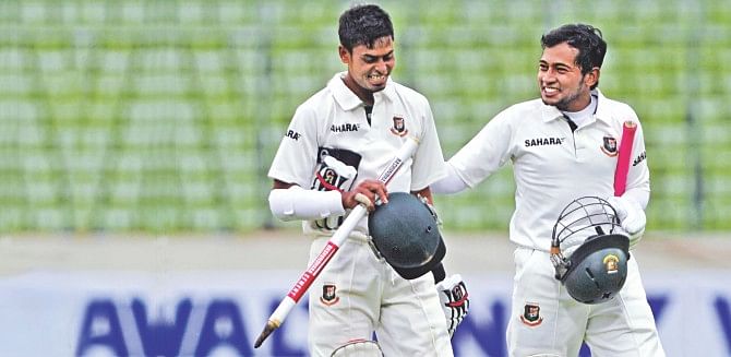 ALL'S WELL THAT ENDS WELL: Bangladesh captain Mushfiqur Rahim (R) and Taijul Islam leave the field smiling after winning the first Test against Zimbabwe at the Sher-e-Bangla National Cricket Stadium in Mirpur yesterday. PHOTO: FIROZ AHMED