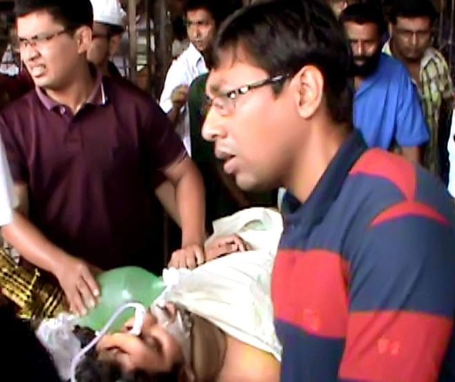 Brutally stabbed by drug addicts, Reza Hasan Taki, a student of Mymensingh Medical College, is being carried for lifting onto a helicopter for transportation to Dhaka Medical College Hospital yesterday. PHOTO: STAR