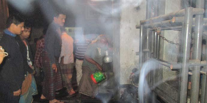 Locals are seen dousing a fire at the district office of Jatiya Samajtantrik Dal (JSD) in Mymensingh after Jamaat-Shibir men hurled two petrol bombs there.