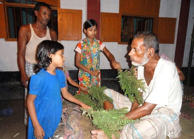 A paralysis patient at Bhadai village in Aditmari upazila of Lalmonirhat being treated with bunches of herbs supplied by a kabiraj. PHOTO: STAR