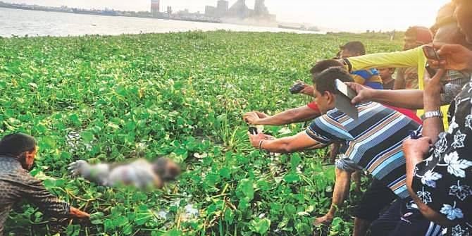 This April 30 file photo shows one of the seven bodies found on the river Shitalakkhya in Narayanganj is being pulled towards the shore. The photo was partly pixelated. 