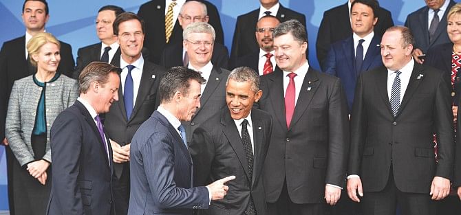 Britain's Prime Minister David Cameron (L), US President Barack Obama (C) and Nato Secretary General Anders Fogh Rasmussen (C) arrive for the family picture at the start of the Nato 2014 summit at the Celtic Manor Hotel in Newport, South Wales, yesterday. Photo: AFP