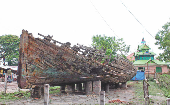 ARTEFACT IN RUINS: This 200-year-old wooden boat, kept under the open sky near the Buddhist temple in Kuakata sea beach since December last year, is getting damaged in sun and rain, thanks to the negligence of the department concerned. PHOTO: STAR