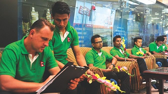 Nepal coach Jack Stefanowski (L) and captain Sagar Thapa are in midst of a discussion while others sit at the VIP lounge at the Hazrat Shahjalal International Airport yesterday after their arrival. The Nepalese team landed here four-and-a-half hours after their scheduled 4:40 pm arrival. PHOTO: FIROZ AHMED
