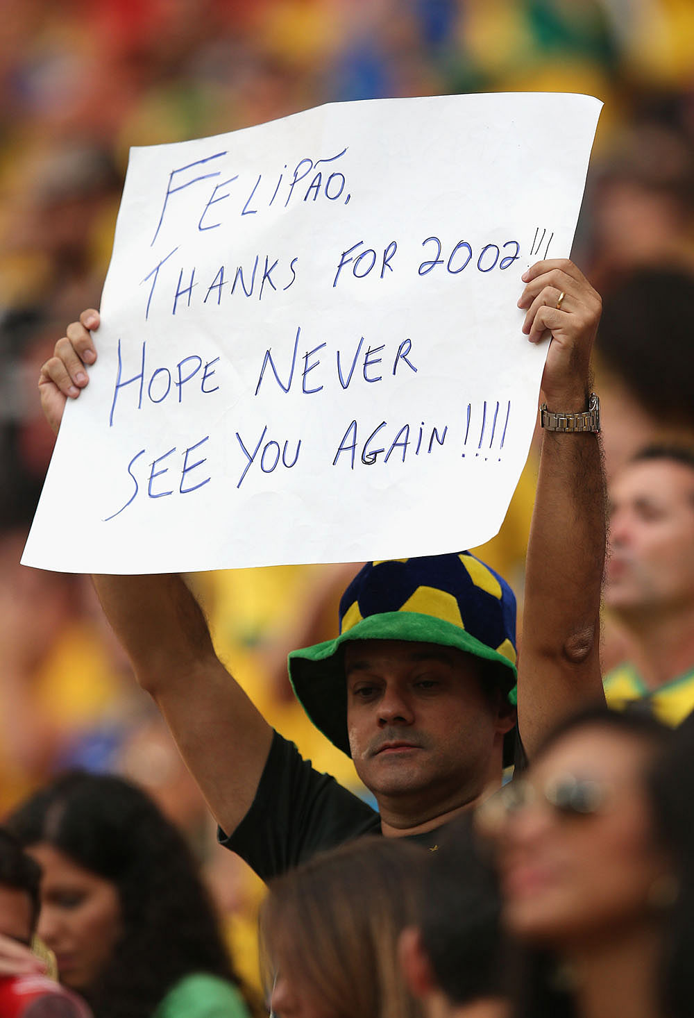 A fan holds a banner prior to the 2014 FIFA World Cup Brazil Third Place Playoff match between Brazil and the Netherlands. Photo: Getty Images