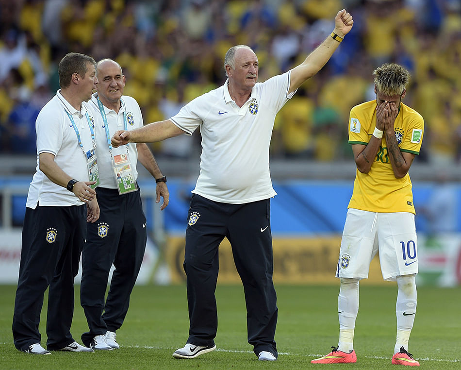 Brazil's coach Luiz Felipe Scolari (C) and Brazil's forward Neymar (R) celebrate after Brazil won their match against Chile in a penalty shoot out after extra-time in the Round of 16 football match between Brazil and Chile at The Mineirao Stadium in Belo Horizonte during the 2014 FIFA World Cup on June 28, 2014. Photo: AFP/Getty Images