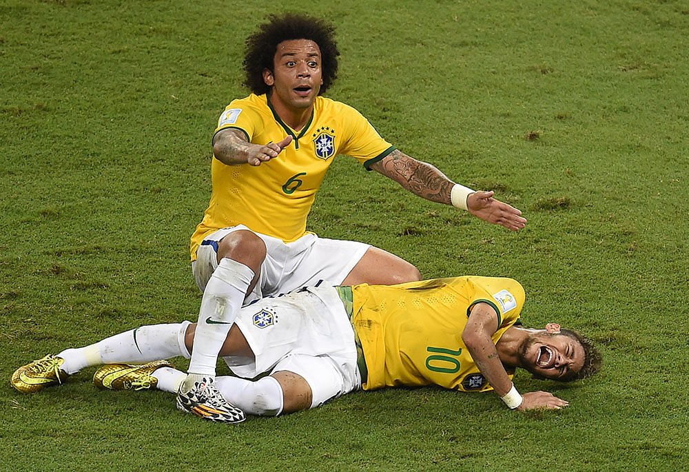 Neymar of Brazil lies injured while Marcelo of Brazil appeals during the 2014 FIFA World Cup Brazil Quarter Final match WITH Colombia. Photo: Getty Images